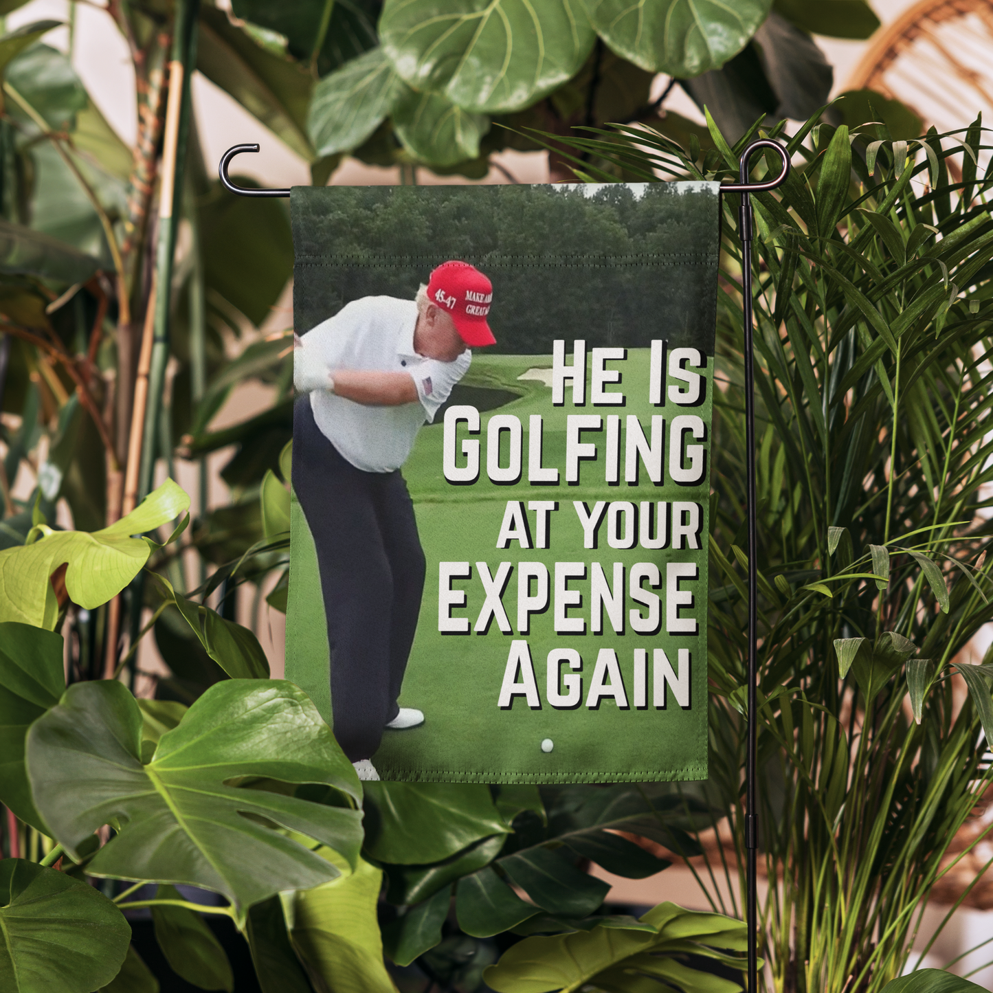 Garden Flag | Yard Flag – "He Is Golfing at Your Expense Again" with Trump Golf Illustration | 12" x 17" Outdoor Political Protest Decor