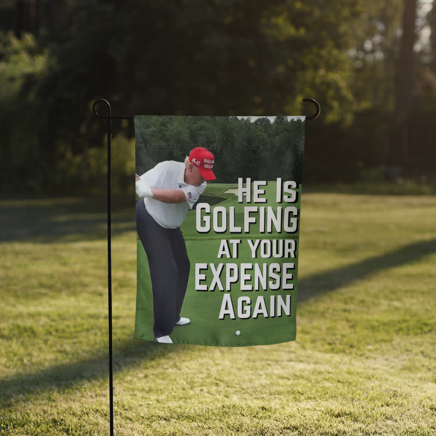 Garden Flag | Yard Flag – "He Is Golfing at Your Expense Again" with Trump Golf Illustration | 12" x 17" Outdoor Political Protest Decor